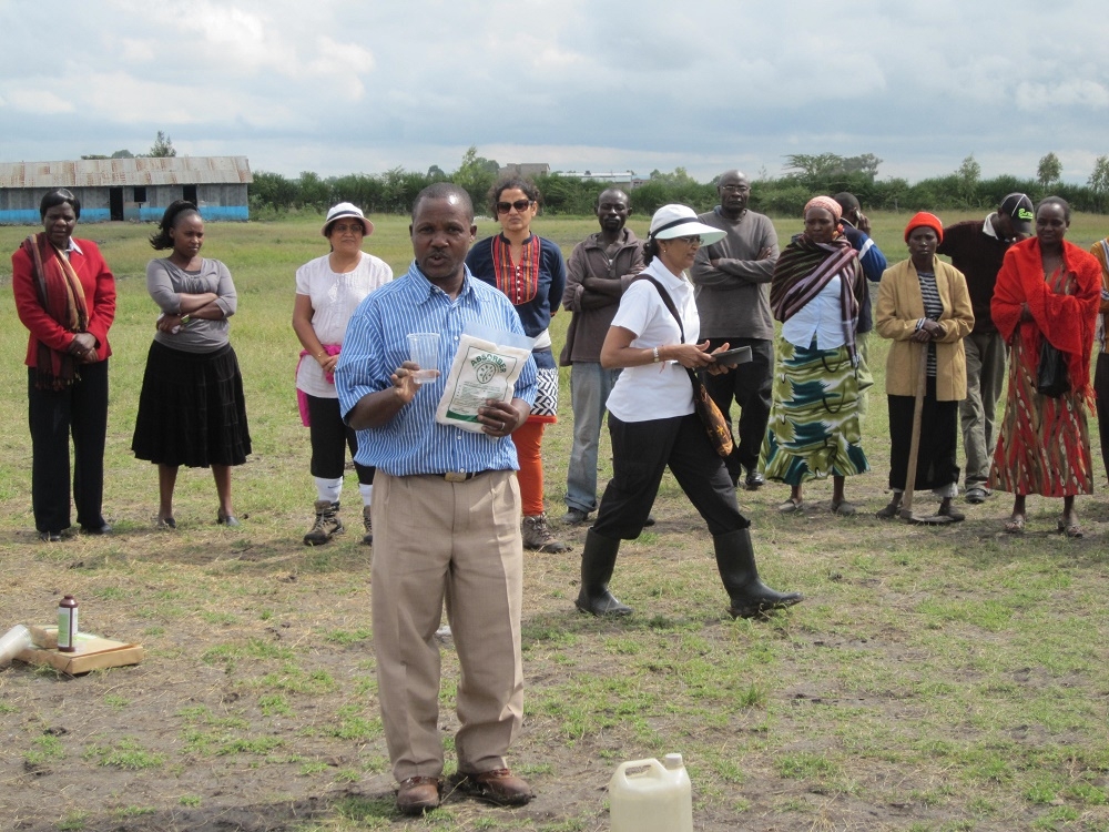 Organix team member demonstrates how to apply Absorber before joining the community in tree planting at Kanani school in Watamu, coastal region of Kenya